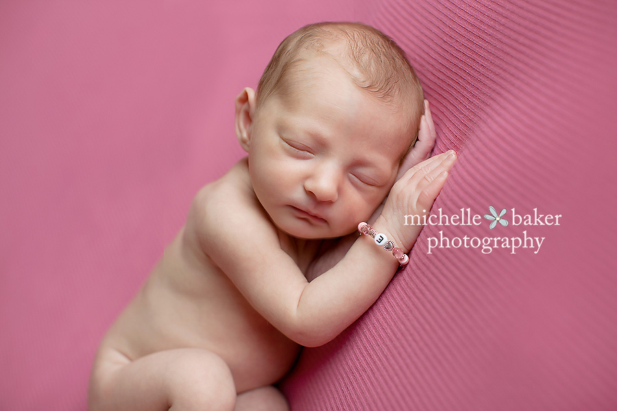 newborn girl on pink