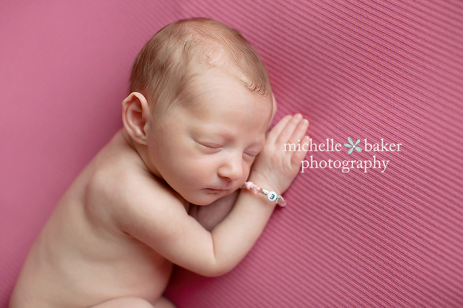 newborn girl on pink