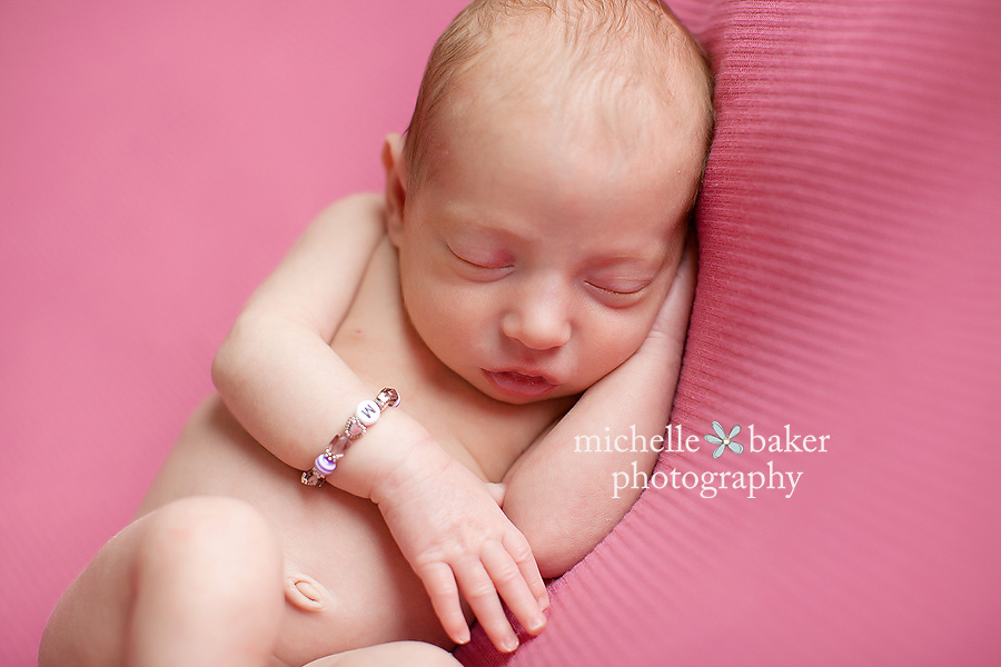 newborn girl on pink