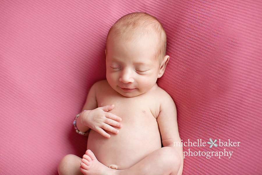 newborn girl on pink