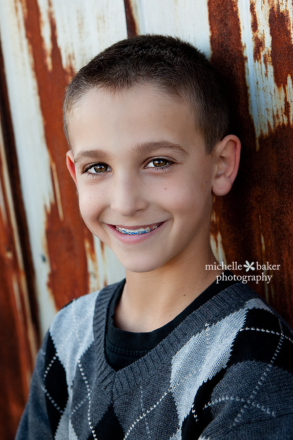 boy leaning against Swedes Farm barn