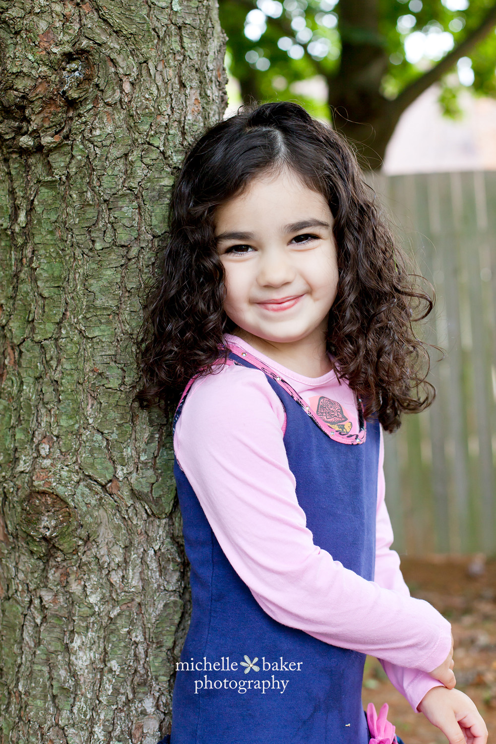 Little girl by the tree