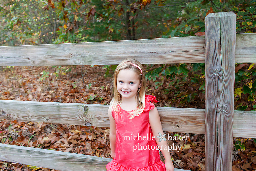 Little girl by fence