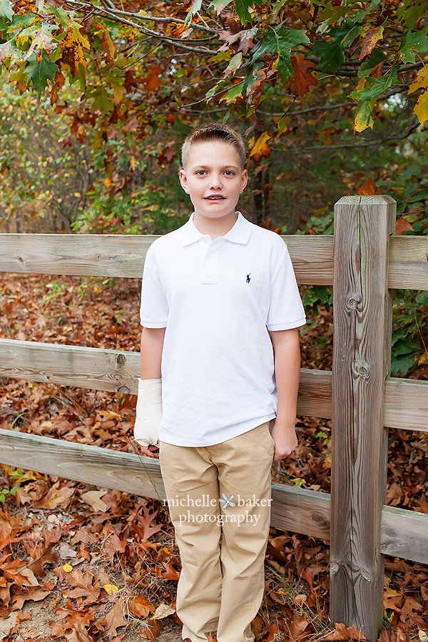 Teen boy leaning on fence