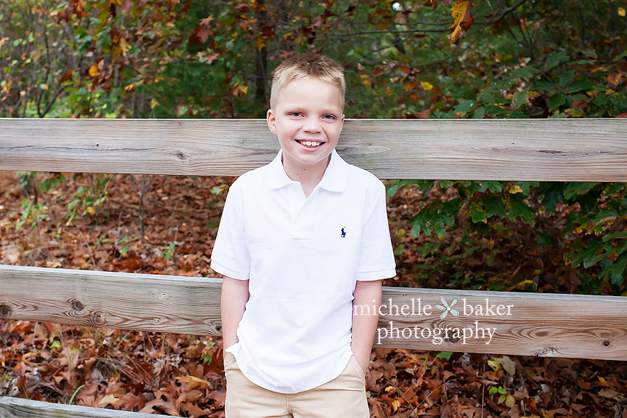 boy leaning on fence