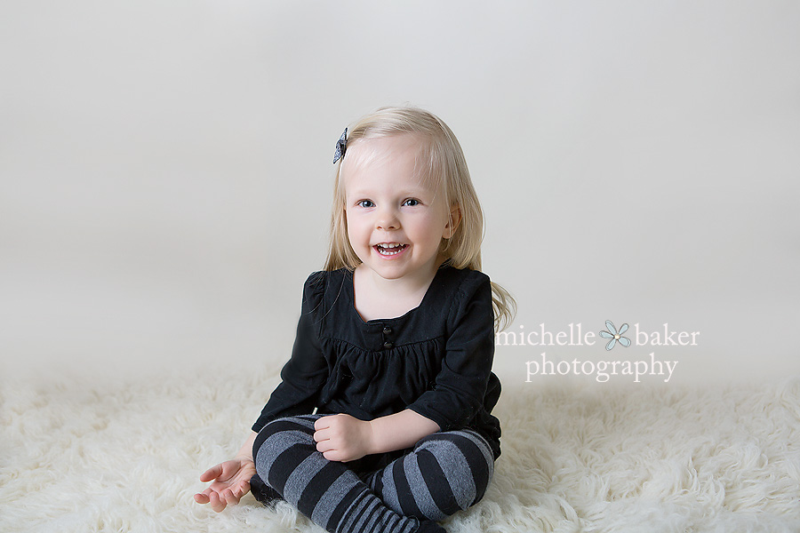 Little girl sitting on floor with her legs crossed