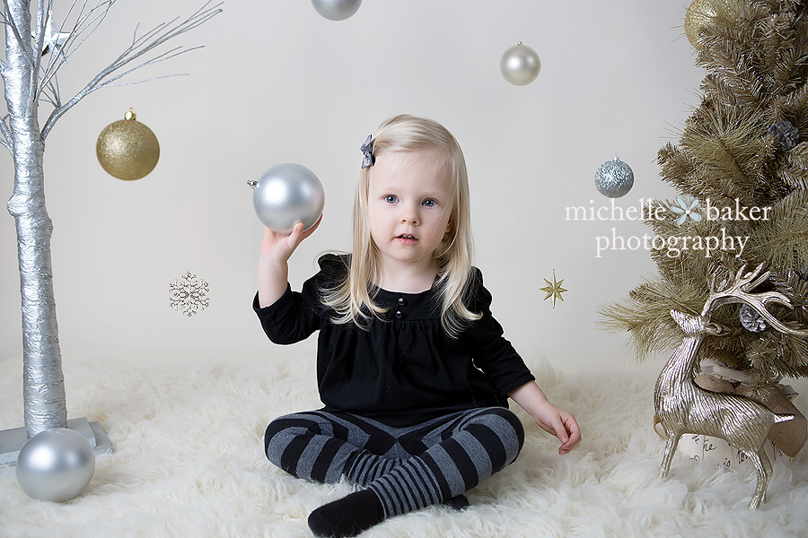 Little girl in holiday set with Christmas decorations