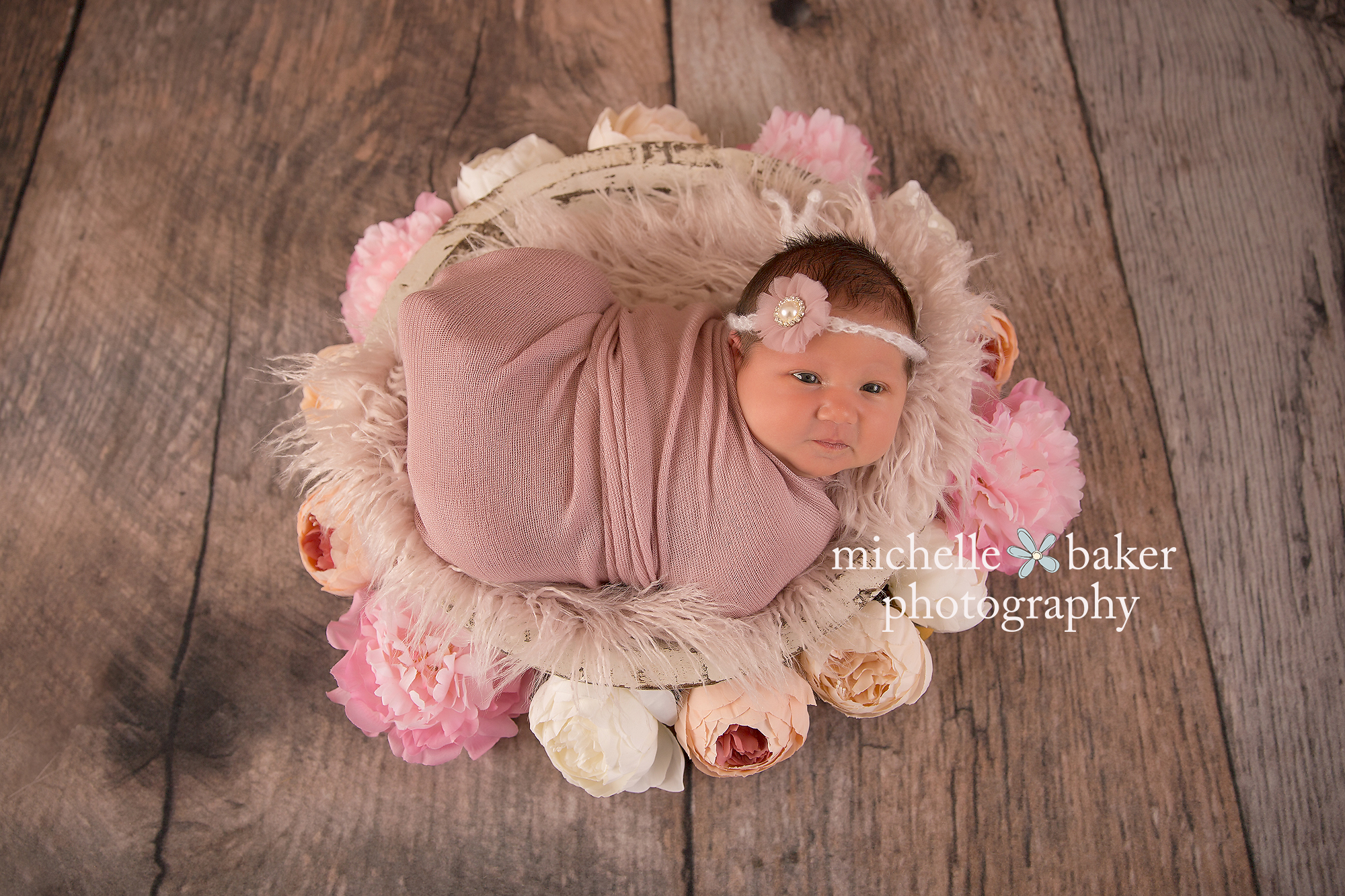 newborn girl with flowers