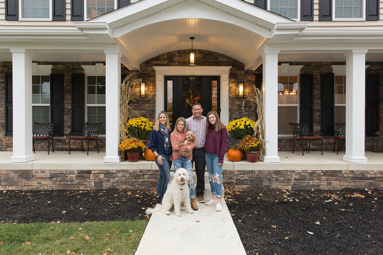 Family portrait in front of house
